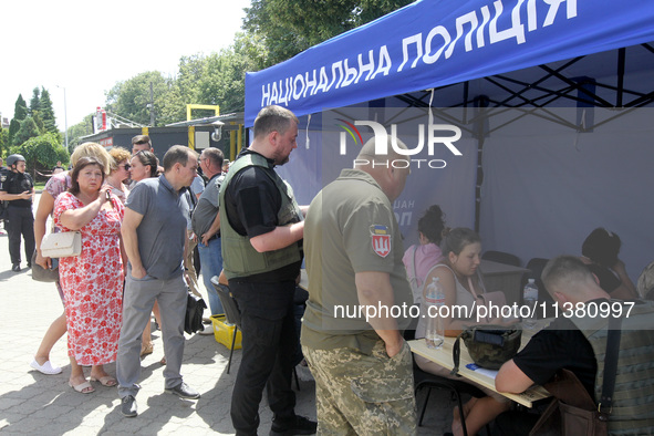 Police officers are helping people near a shopping mall damaged by the Russian missile strike in Dnipro, Ukraine, on July 3, 2024. At least...