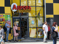 People are standing outside a shop after the Russian missile strike in Dnipro, Ukraine, on July 3, 2024. At least five people are being repo...