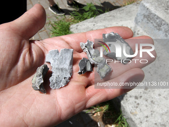 A person is holding fragments found at a shopping mall damaged by the Russian missile strike in Dnipro, Ukraine, on July 3, 2024. At least f...