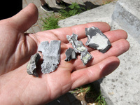 A person is holding fragments found at a shopping mall damaged by the Russian missile strike in Dnipro, Ukraine, on July 3, 2024. At least f...