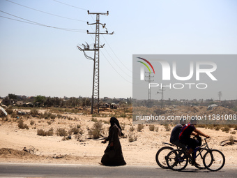 Palestinians are walking on Salah El Din Street in Deir al-Balah in the central Gaza Strip on July 3, 2024, amid the ongoing conflict betwee...