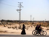 Palestinians are walking on Salah El Din Street in Deir al-Balah in the central Gaza Strip on July 3, 2024, amid the ongoing conflict betwee...