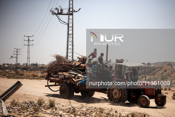 Palestinians are walking on Salah El Din Street in Deir al-Balah in the central Gaza Strip on July 3, 2024, amid the ongoing conflict betwee...