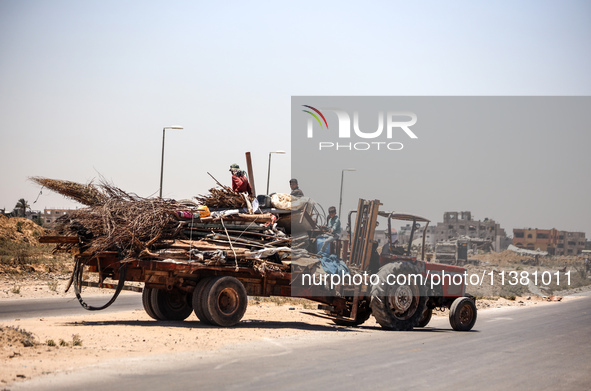 Palestinians are walking on Salah El Din Street in Deir al-Balah in the central Gaza Strip on July 3, 2024, amid the ongoing conflict betwee...