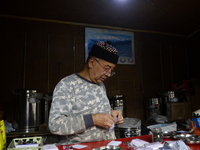 A man is selling tea in a shop in Darjeeling, India, on July 2, 2024. People are shopping in a vegetable market in Darjeeling, India, on Jul...