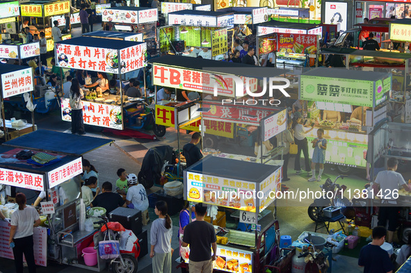 Citizens are enjoying food and leisure time at a night market in Nanjing, China, on July 3, 2024. 