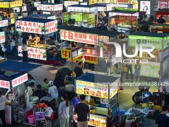 Citizens are enjoying food and leisure time at a night market in Nanjing, China, on July 3, 2024. (