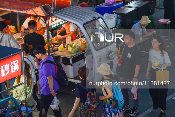 Citizens are enjoying food and leisure time at a night market in Nanjing, China, on July 3, 2024. 