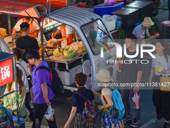 Citizens are enjoying food and leisure time at a night market in Nanjing, China, on July 3, 2024. (