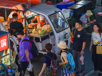 Citizens are enjoying food and leisure time at a night market in Nanjing, China, on July 3, 2024. (