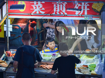 Citizens are enjoying food and leisure time at a night market in Nanjing, China, on July 3, 2024. (