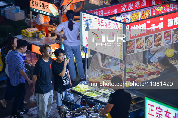 Citizens are enjoying food and leisure time at a night market in Nanjing, China, on July 3, 2024. 