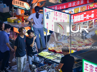 Citizens are enjoying food and leisure time at a night market in Nanjing, China, on July 3, 2024. (