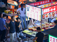 Citizens are enjoying food and leisure time at a night market in Nanjing, China, on July 3, 2024. (