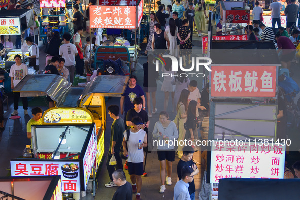 Citizens are enjoying food and leisure time at a night market in Nanjing, China, on July 3, 2024. 