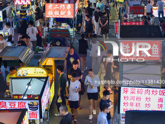 Citizens are enjoying food and leisure time at a night market in Nanjing, China, on July 3, 2024. (