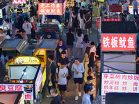 Citizens are enjoying food and leisure time at a night market in Nanjing, China, on July 3, 2024. (