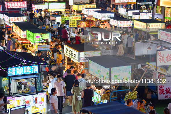 Citizens are enjoying food and leisure time at a night market in Nanjing, China, on July 3, 2024. 