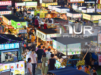 Citizens are enjoying food and leisure time at a night market in Nanjing, China, on July 3, 2024. (