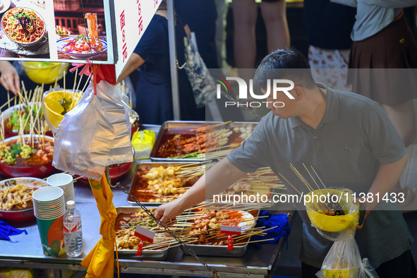 Citizens are enjoying food and leisure time at a night market in Nanjing, China, on July 3, 2024. 