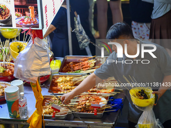 Citizens are enjoying food and leisure time at a night market in Nanjing, China, on July 3, 2024. (