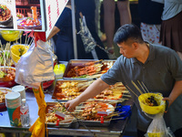 Citizens are enjoying food and leisure time at a night market in Nanjing, China, on July 3, 2024. (