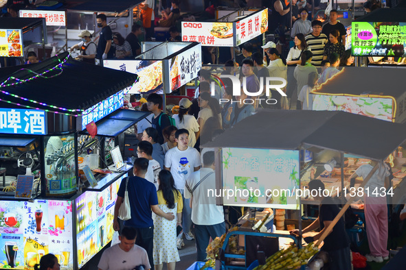 Citizens are enjoying food and leisure time at a night market in Nanjing, China, on July 3, 2024. 