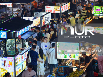 Citizens are enjoying food and leisure time at a night market in Nanjing, China, on July 3, 2024. (