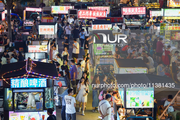 Citizens are enjoying food and leisure time at a night market in Nanjing, China, on July 3, 2024. 