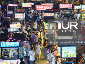 Citizens are enjoying food and leisure time at a night market in Nanjing, China, on July 3, 2024. (