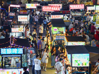 Citizens are enjoying food and leisure time at a night market in Nanjing, China, on July 3, 2024. (