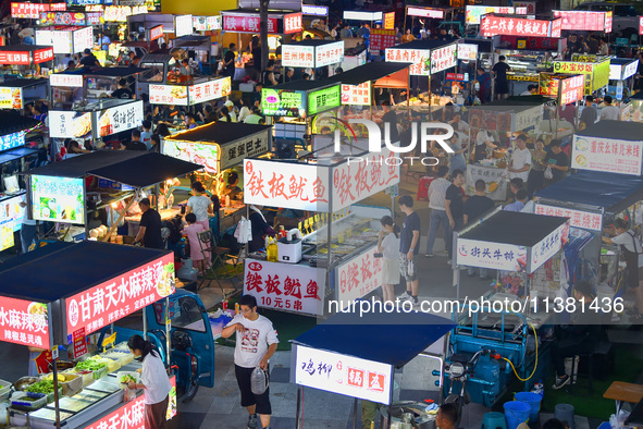 Citizens are enjoying food and leisure time at a night market in Nanjing, China, on July 3, 2024. 