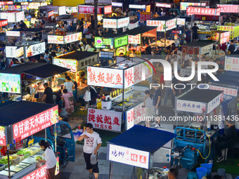 Citizens are enjoying food and leisure time at a night market in Nanjing, China, on July 3, 2024. (