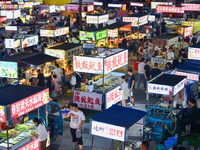 Citizens are enjoying food and leisure time at a night market in Nanjing, China, on July 3, 2024. (