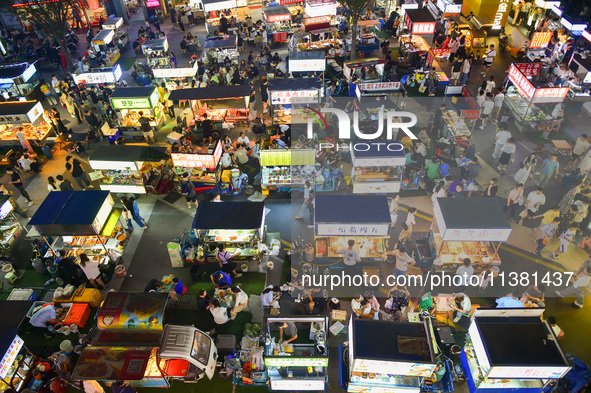 Citizens are enjoying food and leisure time at a night market in Nanjing, China, on July 3, 2024. 