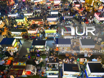 Citizens are enjoying food and leisure time at a night market in Nanjing, China, on July 3, 2024. (