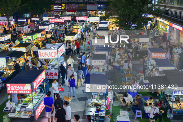 Citizens are enjoying food and leisure time at a night market in Nanjing, China, on July 3, 2024. 