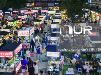 Citizens are enjoying food and leisure time at a night market in Nanjing, China, on July 3, 2024. (