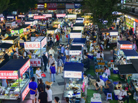 Citizens are enjoying food and leisure time at a night market in Nanjing, China, on July 3, 2024. (