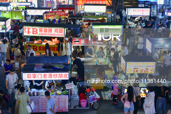 Citizens are enjoying food and leisure time at a night market in Nanjing, China, on July 3, 2024. 