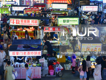 Citizens are enjoying food and leisure time at a night market in Nanjing, China, on July 3, 2024. (