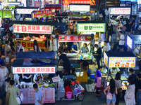 Citizens are enjoying food and leisure time at a night market in Nanjing, China, on July 3, 2024. (