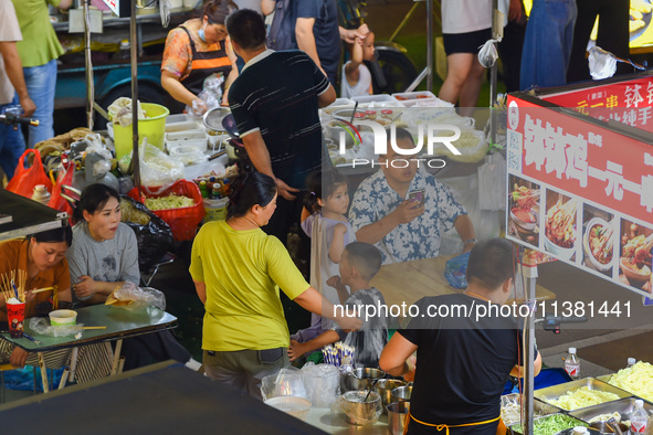 Citizens are enjoying food and leisure time at a night market in Nanjing, China, on July 3, 2024. 