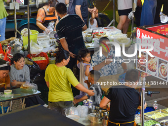 Citizens are enjoying food and leisure time at a night market in Nanjing, China, on July 3, 2024. (