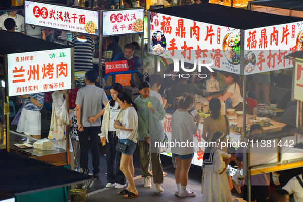 Citizens are enjoying food and leisure time at a night market in Nanjing, China, on July 3, 2024. 