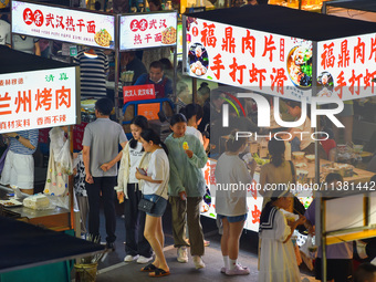 Citizens are enjoying food and leisure time at a night market in Nanjing, China, on July 3, 2024. (