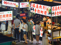 Citizens are enjoying food and leisure time at a night market in Nanjing, China, on July 3, 2024. (