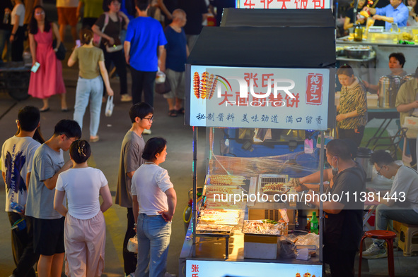 Citizens are enjoying food and leisure time at a night market in Nanjing, China, on July 3, 2024. 