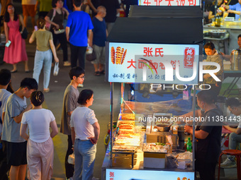 Citizens are enjoying food and leisure time at a night market in Nanjing, China, on July 3, 2024. (