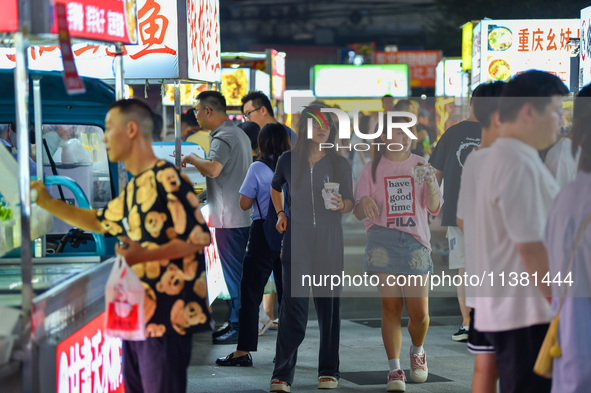 Citizens are enjoying food and leisure time at a night market in Nanjing, China, on July 3, 2024. 